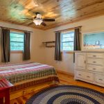 Image showing another view of bedroom in island cabin, shows dresser and windows