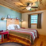 Second bedroom in the island cabin showing a bed and bedside tables