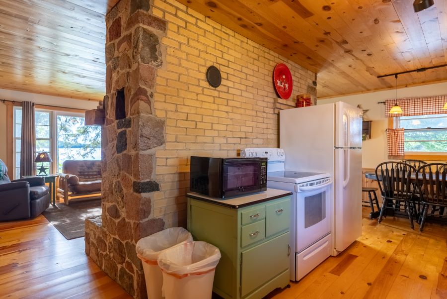 Image showing kitchen section of island cabin. Shoes stove, fridge and microwave