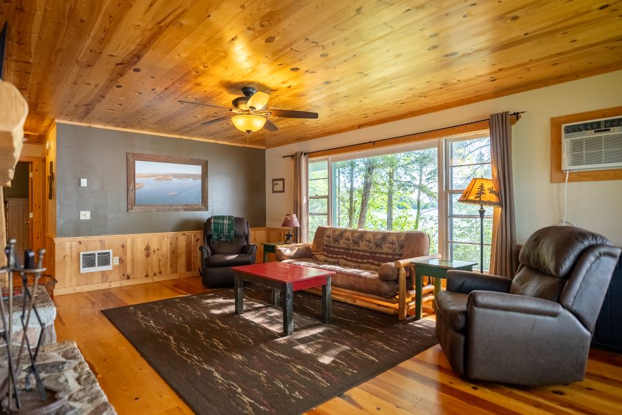 Image showing living room in island cabin. Shoes couches and reclining chair 